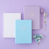 Tsuki Endless Summer Limited Edition Bullet Journals in Lilac Bloom and Petal Blue with eco-friendly gift box packaging and Tsuki Endless Summer washi tape rolls with light blue hydrangea flowers on lilac background