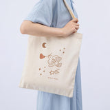 Tsuki ‘Moonflower’ Limited Edition Tote Bag shown on model’s arm on light blue background