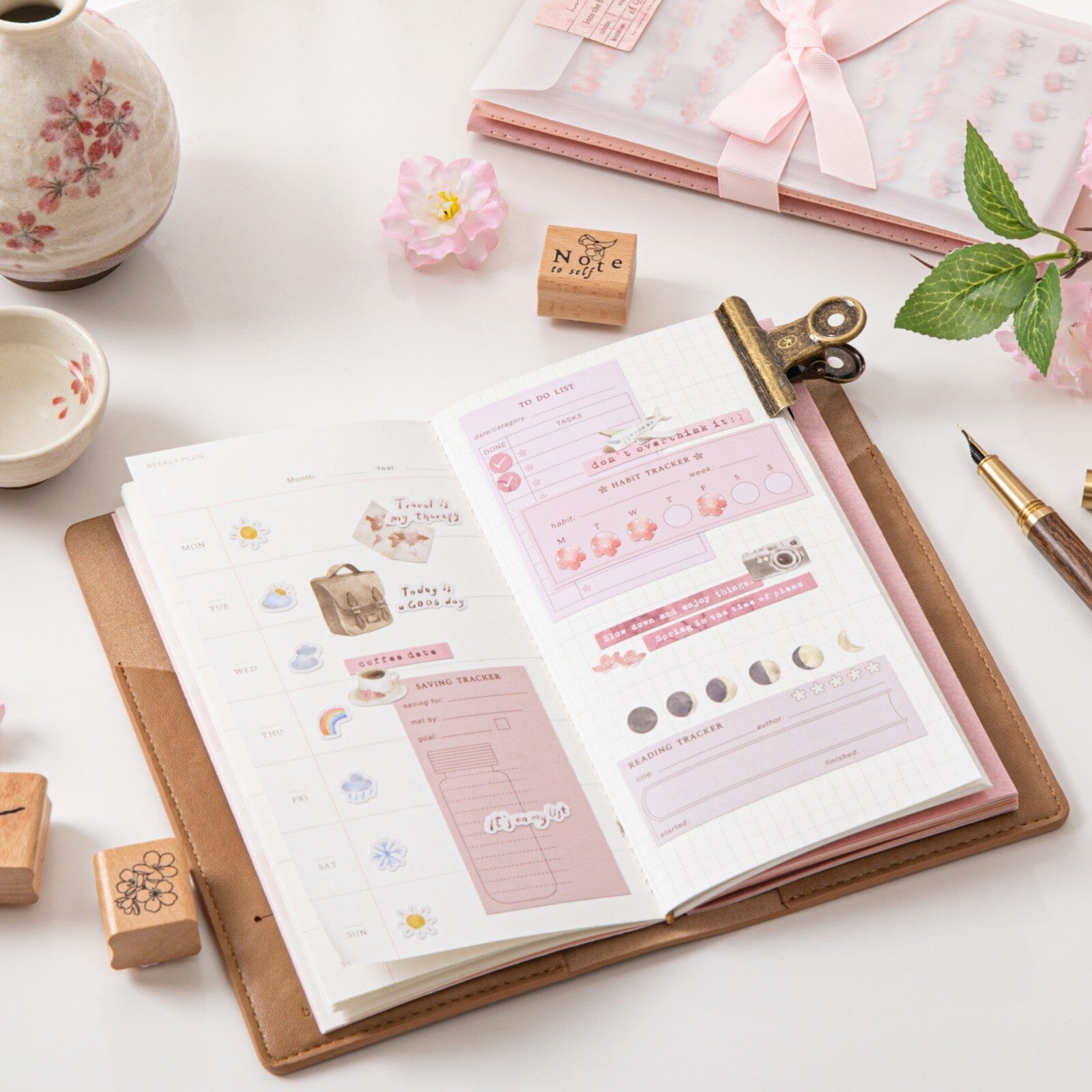 Hand holding grid paper refill from Hinoki travel notebook