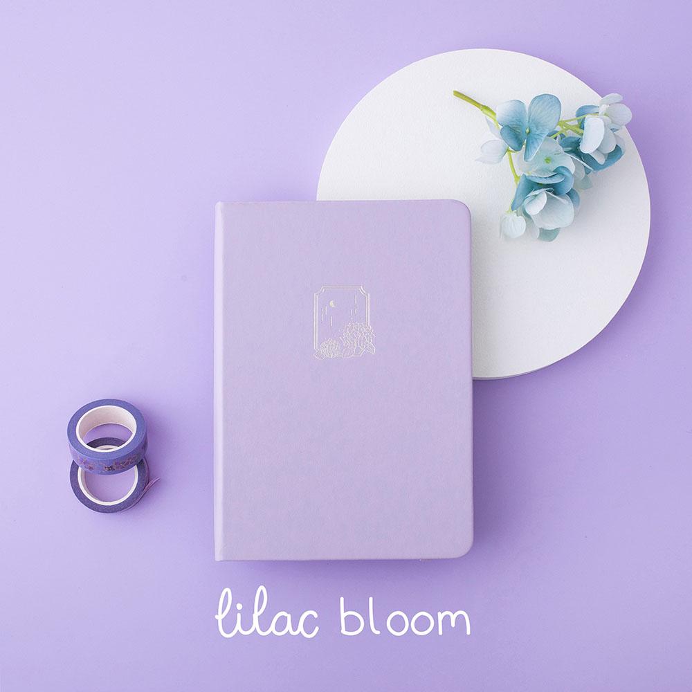 Tsuki Endless Summer Limited Edition Bullet Journal in Lilac Bloom with white circle and light blue hydrangea flowers and Tsuki Endless Summer Washi tape rolls on lilac background