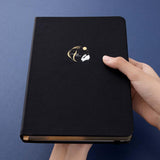 Tsuki ‘Moonlit Wish’ Limited Edition Bullet Journal held in hands at an angle in dark blue background