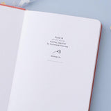 Close up of open front page of Tsuki ‘Suzume’ Limited Edition Bullet Journal on lilac background