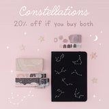 Flatlay of black constellations bullet journal and washi tape set with the words “constellations 20% off if you buy both” 
