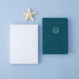 Tsuki sea green velvet Dolphin Days notebook with eco-friendly box packaging and starfish on blue background