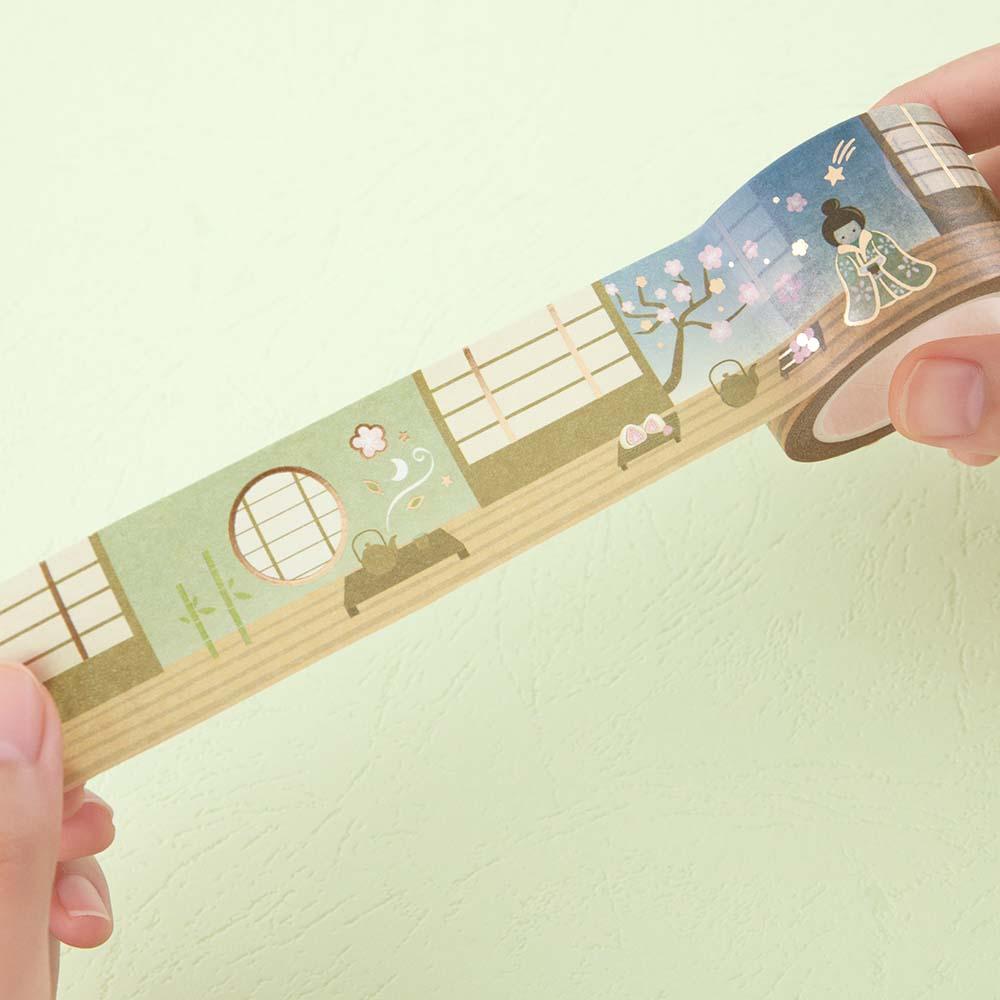 Tsuki ‘Matcha Ichigo’ Washi wide illustration tape held in hands in matcha green background