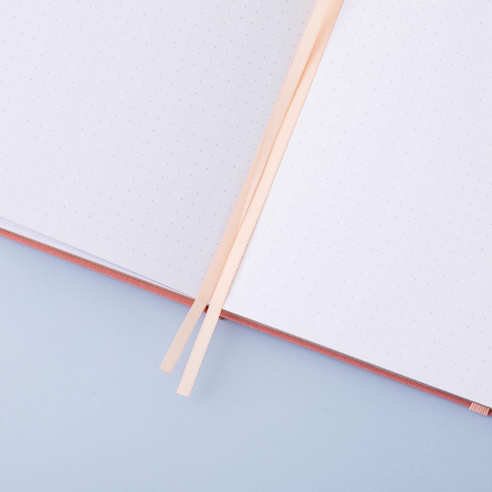 Close up of open page spread of Tsuki ‘Suzume’ Limited Edition Bullet Journal with two bookmark ribbons on lilac background