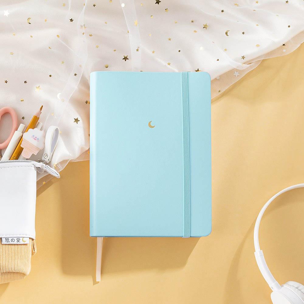 Bluebell Tsuki Pastel Edition Bullet Journal with netting and tsuki pastel pop up pencil case and pens and scissors on peach background