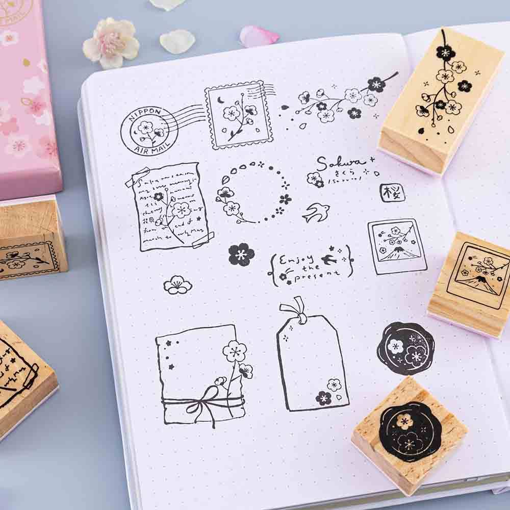 Close up of Tsuki ‘Sakura Journey’ Bullet Journal Stamps on open bullet journal page on light blue background