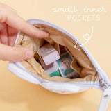 Close up of open Tsuki ‘Four Seasons’ Embroidered Pop-Up Pencil Case by Notebook Therapy x Milkkoyo with small inner pockets held in hand on honey yellow background