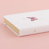 Close up of Tsuki Cloud White ‘Flutter + Dream’ Limited Edition Bullet Journal by Notebook Therapy x Pelinkan on pastel pink background