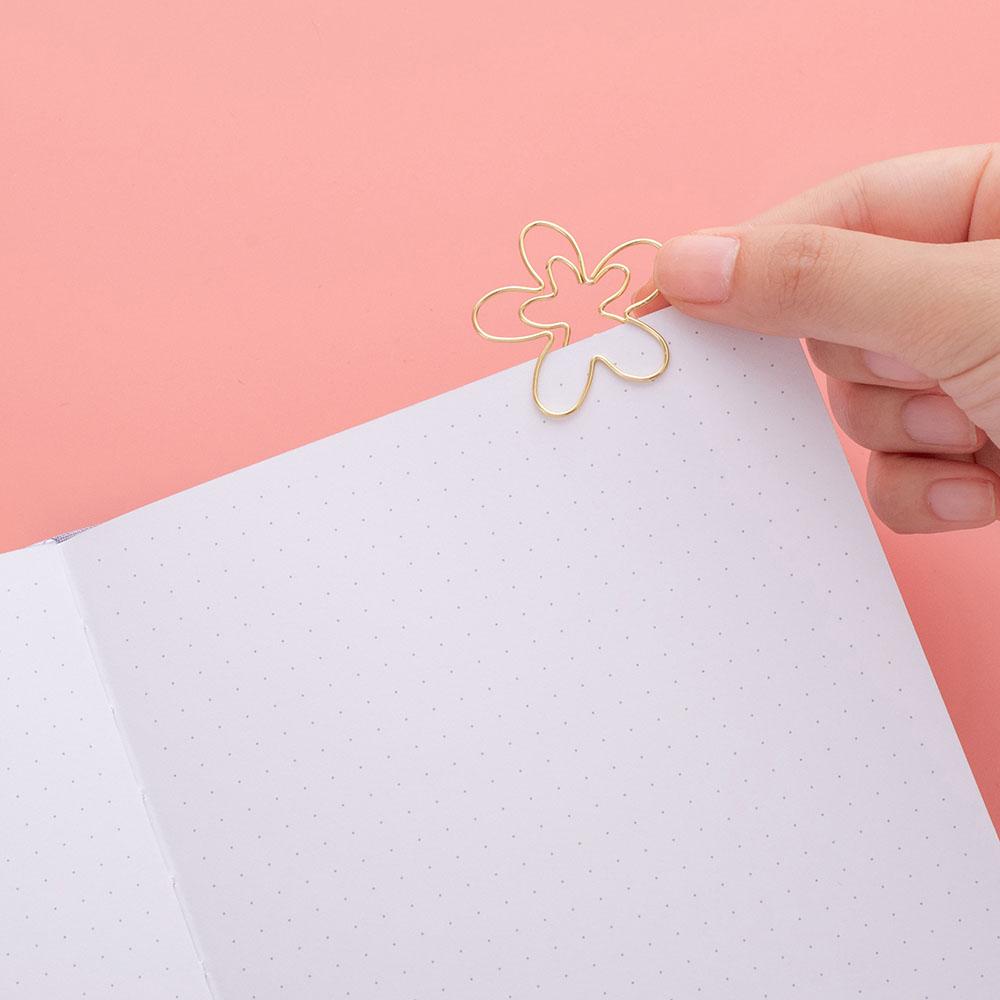 Close up of open page of Tsuki ‘Full Bloom’ Limited Edition Bullet Journal with free gift on coral pink background