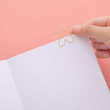 Close up of open page of Tsuki ‘Full Bloom’ Limited Edition Bullet Journal with free gift on coral pink background