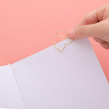 Close up of open page of Tsuki ‘Suzume’ Limited Edition Bullet Journal with free gift on coral pink background