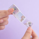 Tsuki Endless Summer Washi Stamp Tape roll held in hands on lilac background