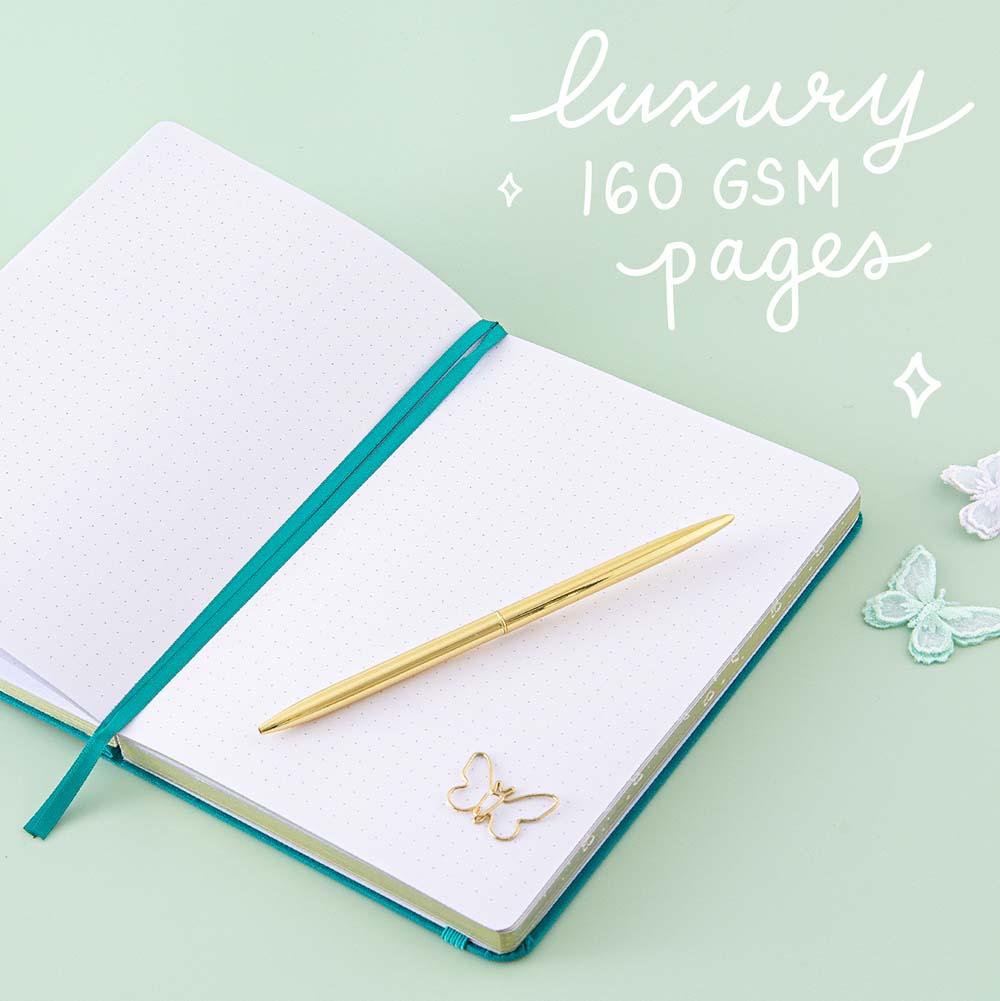 Open page spread of Tsuki Teal Sky ‘Flutter + Dream’ Limited Edition Bullet Journal by Notebook Therapy x Pelinkan with luxury 160GSM pages and free butterfly bookmark gift with gold pen and butterflies on mint background