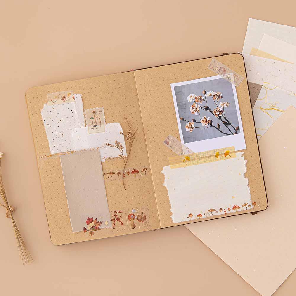 Tsuki Mixed Scrapbook Paper Pack on open Tsuki Kraft Paper Limited Edition Bullet Journal spread with polaroid picture and Tsuki ‘Maple Dreams’ Washi Tapes on beige background