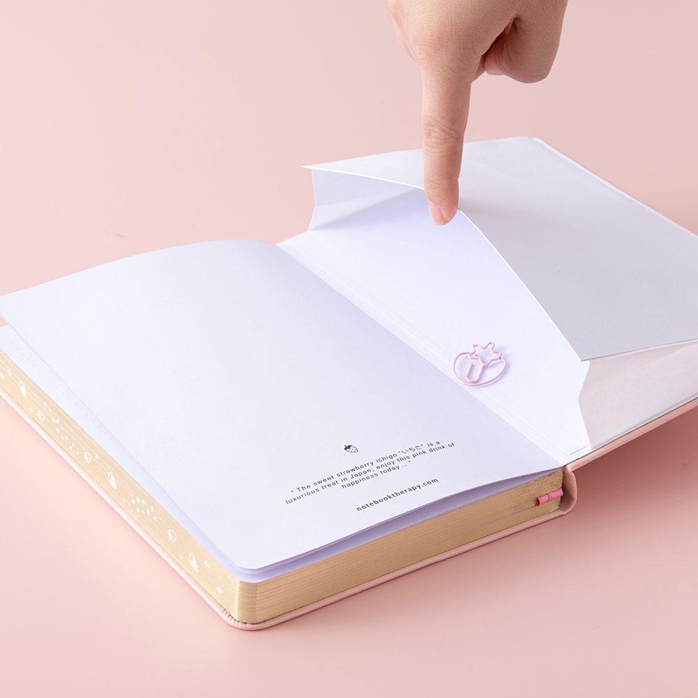Open back page pocket of Tsuki ‘Ichigo’ Limited Edition Boba Bullet Journal and free gift on light pink background