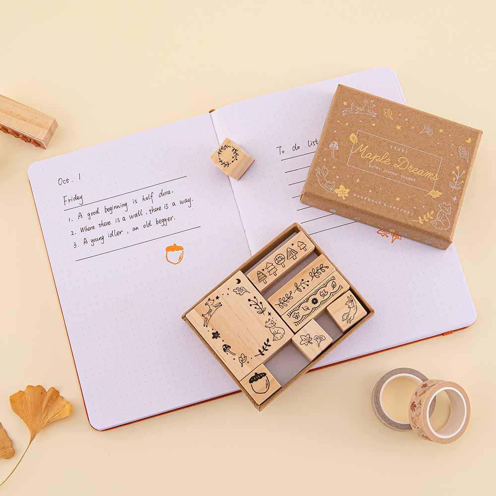 Tsuki ‘Maple Dreams’ Bullet Journal Stamp Set on open Tsuki ‘Kitsune’ Limited Edition Fox Bullet Journal pages with Tsuki ‘Maple Dreams’ Washi Tapes with autumn leaves on cream background