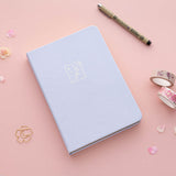 Tsuki ‘Sakura Journey’ Limited Edition Bullet Journal with free bookmark gift with pen and cherry blossom petals with Tsuki ‘Sakura Journey’ Washi Tape Set on pink background