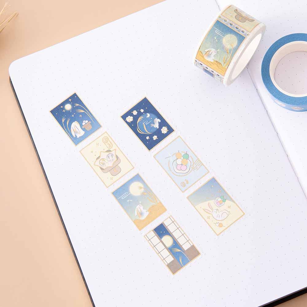 Tsuki ‘Moonlit Wish’ Stamp Washi Tape on open bullet journal pages on light brown background