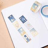 Tsuki ‘Moonlit Wish’ Stamp Washi Tape on open bullet journal pages on light brown background