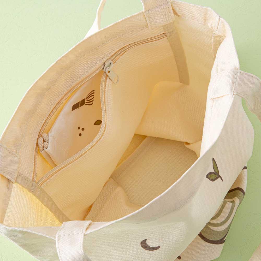 Close up of the inside of Tsuki ‘Matcha Matcha’ Tote Bag with inside zippable pocket and free matching drawstring pouch on matcha green background