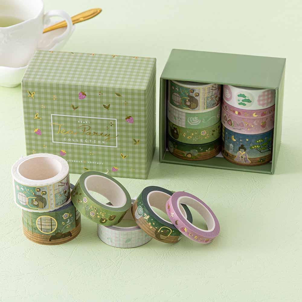 Close up of Tsuki ‘Matcha Ichigo’ Washi Tape Set with tea cup and saucer and spoon on matcha green background