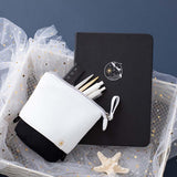 Tsuki Ocean Edition pop up standing pencil case in Orca Black with deep black vegan leather Playful Orca limited edition notebook in basket with pens and starfish in dark blue background