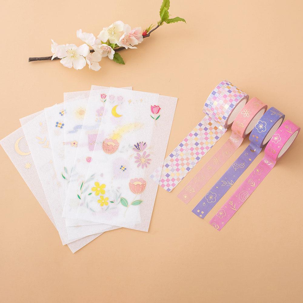 Tsuki Floral collection washi tapes + sticker sheets layout out on the peach background