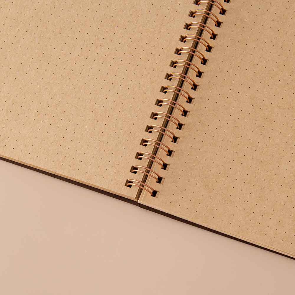 Close up of open page spread of Tsuki ‘Maple Dreams’ Kraft Paper Ringbound Bullet Journal on beige background
