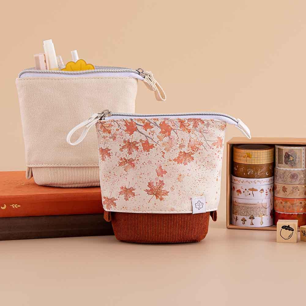 Tsuki ‘Maple Dreams’ Pop-Up Pencil cases in stone and maple with Tsuki ‘Kitsune’ Limited Edition Fox Bullet Journal and Tsuki ‘Nara’ Limited Edition notebook with Tsuki ‘Maple Dreams’ Washi Tape Set and Tsuki ‘Maple Dreams’ Bullet Journal Stamps in beige background