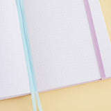 Close up of the front cover of Tsuki Four Seasons: Summer Edition Bullet Journal designed with @milkkoyo on honey yellow background