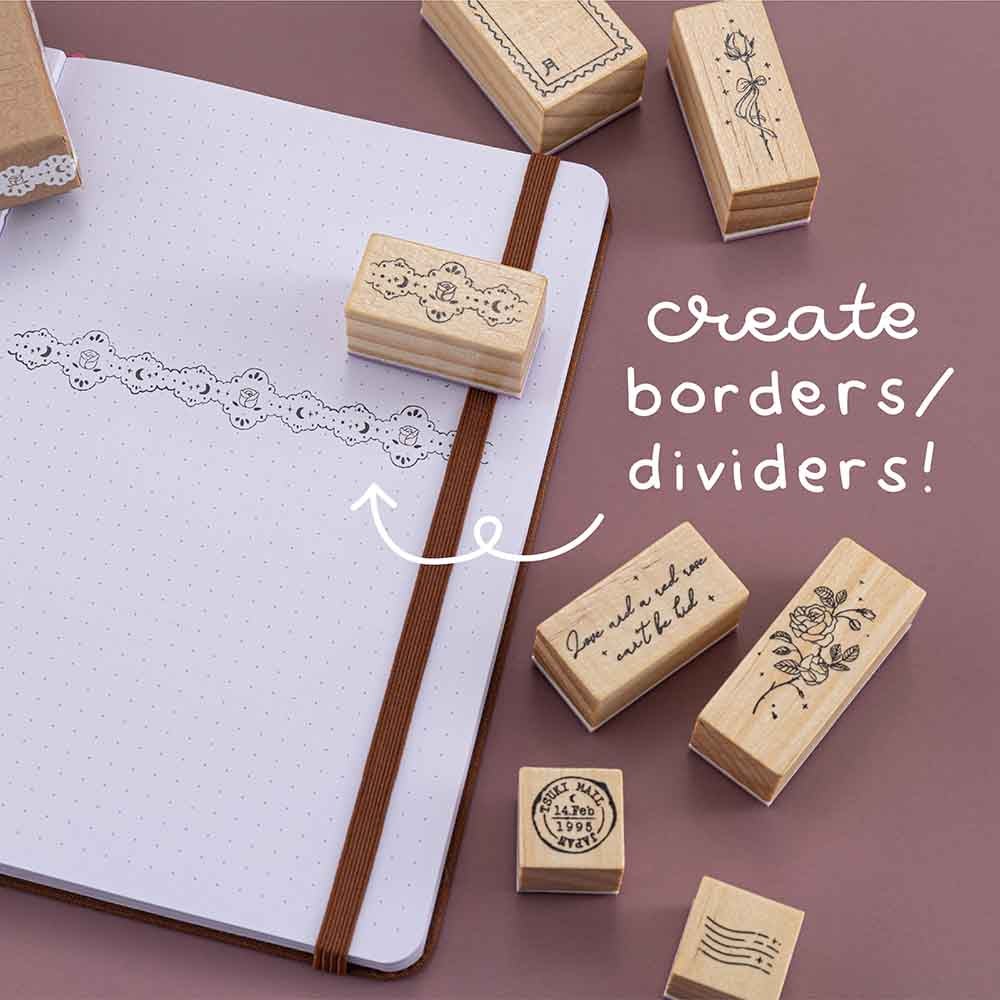 Tsuki ‘Vintage Rose’ Bullet Journal Stamp Set with vintage aesthetic on open Tsuki ‘Vintage Rose’ Limited Edition Bullet Journal to create border dividers on mauve background