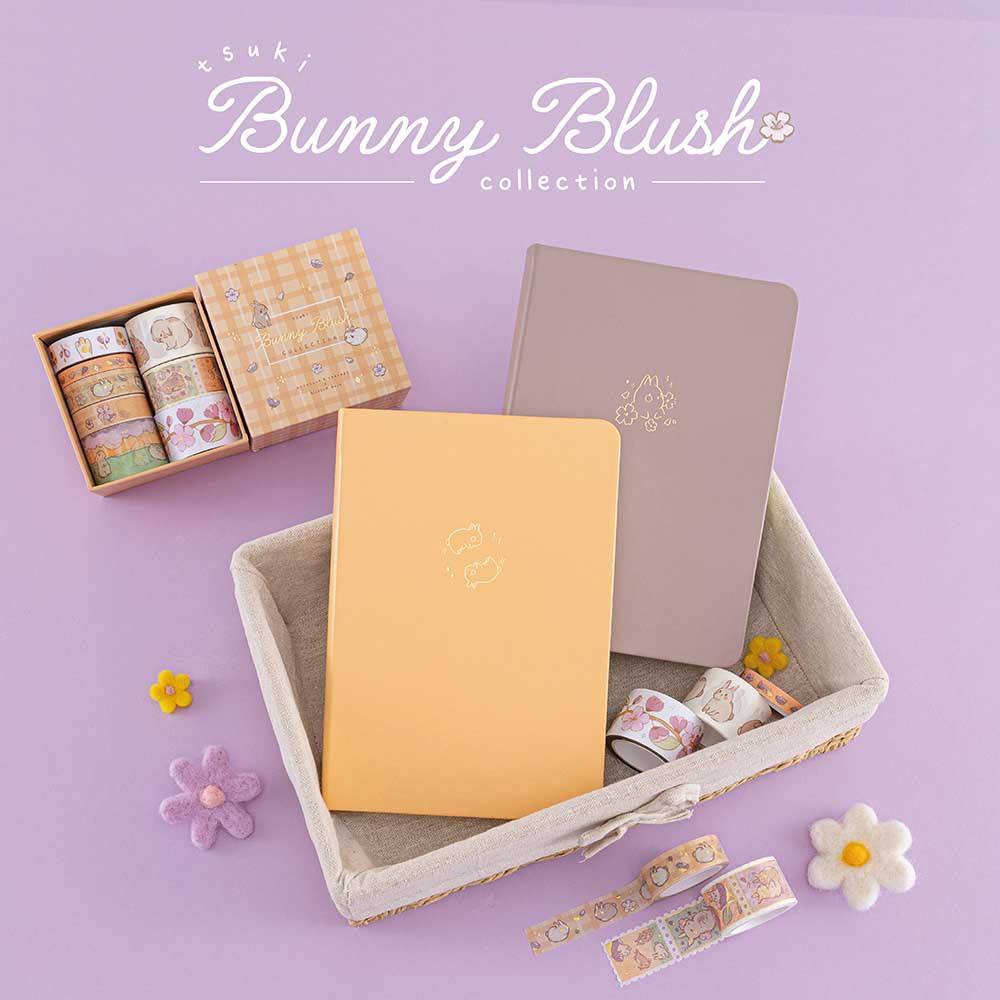 Tsuki Honey Butter ‘Bunny Blush’ Limited Edition Bullet Journal designed with Blossom Bujo with Tsuki Blush Pink ‘Bunny Blush’ Limited Edition Bullet Journal in basket designed with Blossom Bujo and Tsuki ‘Bunny Blush’ Washi Tape Set with felt flowers on lilac background