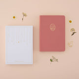 Flatlay of tsuki neko neko pink cat bullet journal with the recyclable gift box