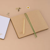 Tsuki Mori green bullet journal laid flat showing kraft paper pages