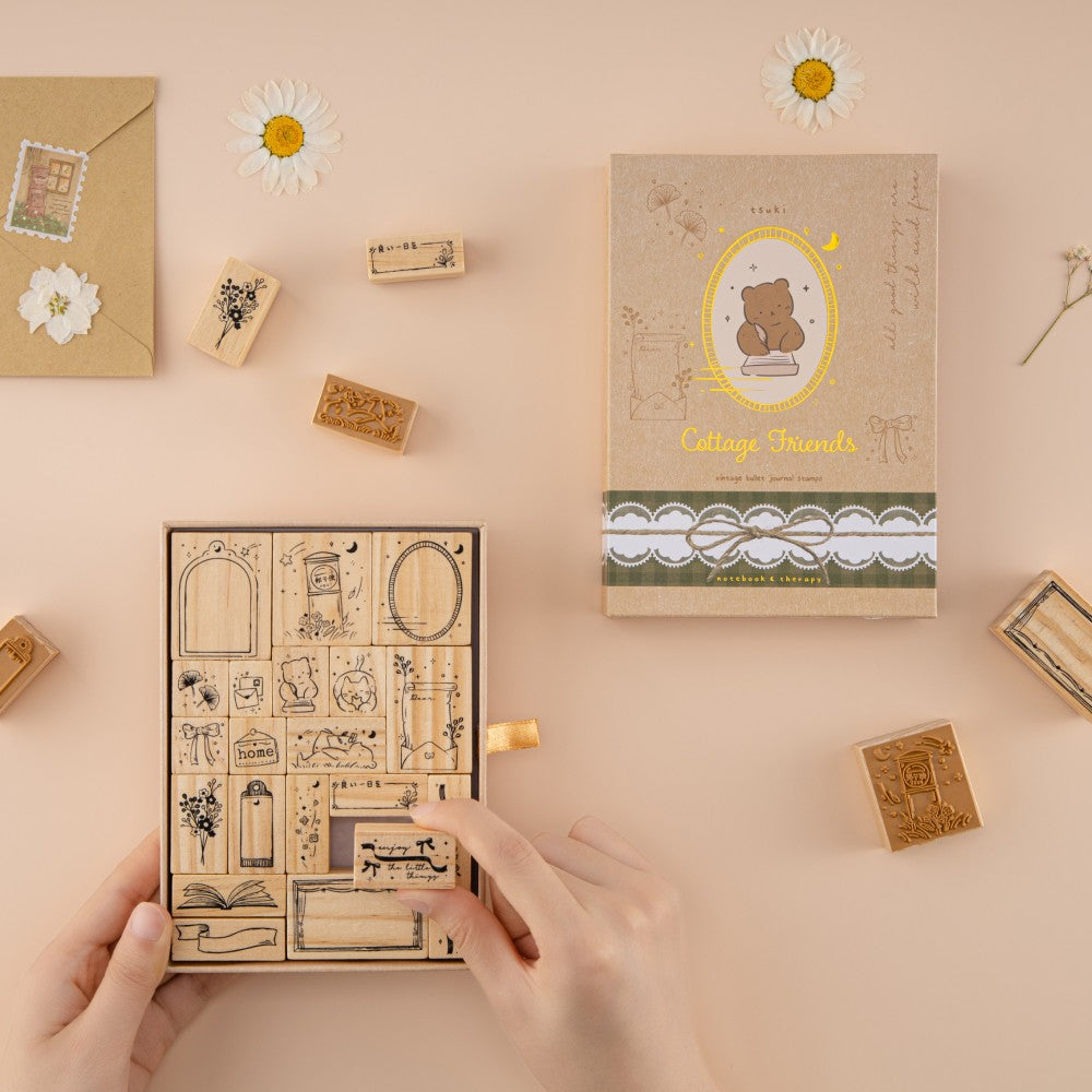 Hands holding stamp set and picking up one stamp
