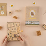 Hands holding stamp set and picking up one stamp