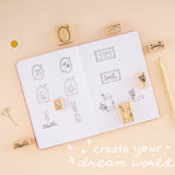 Stamp swatch on bullet journal with lettering ‘create your dream world’