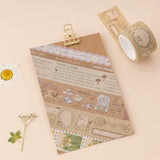Cottage Friends washi tape swatch on kraft paper with gold clip