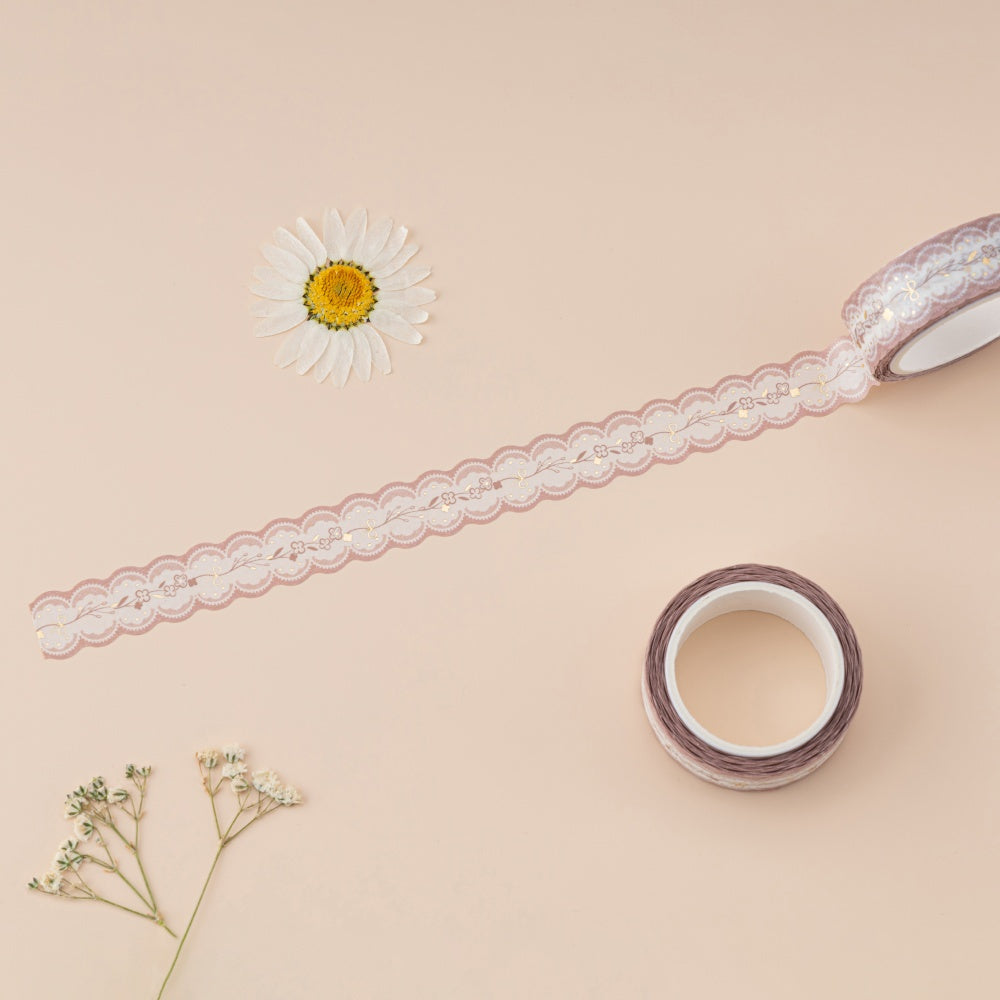 Lace die cut washi tape with gold foil details on beige background