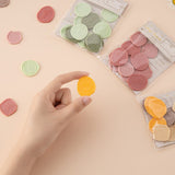 Hand holding yellow wax seal sticker