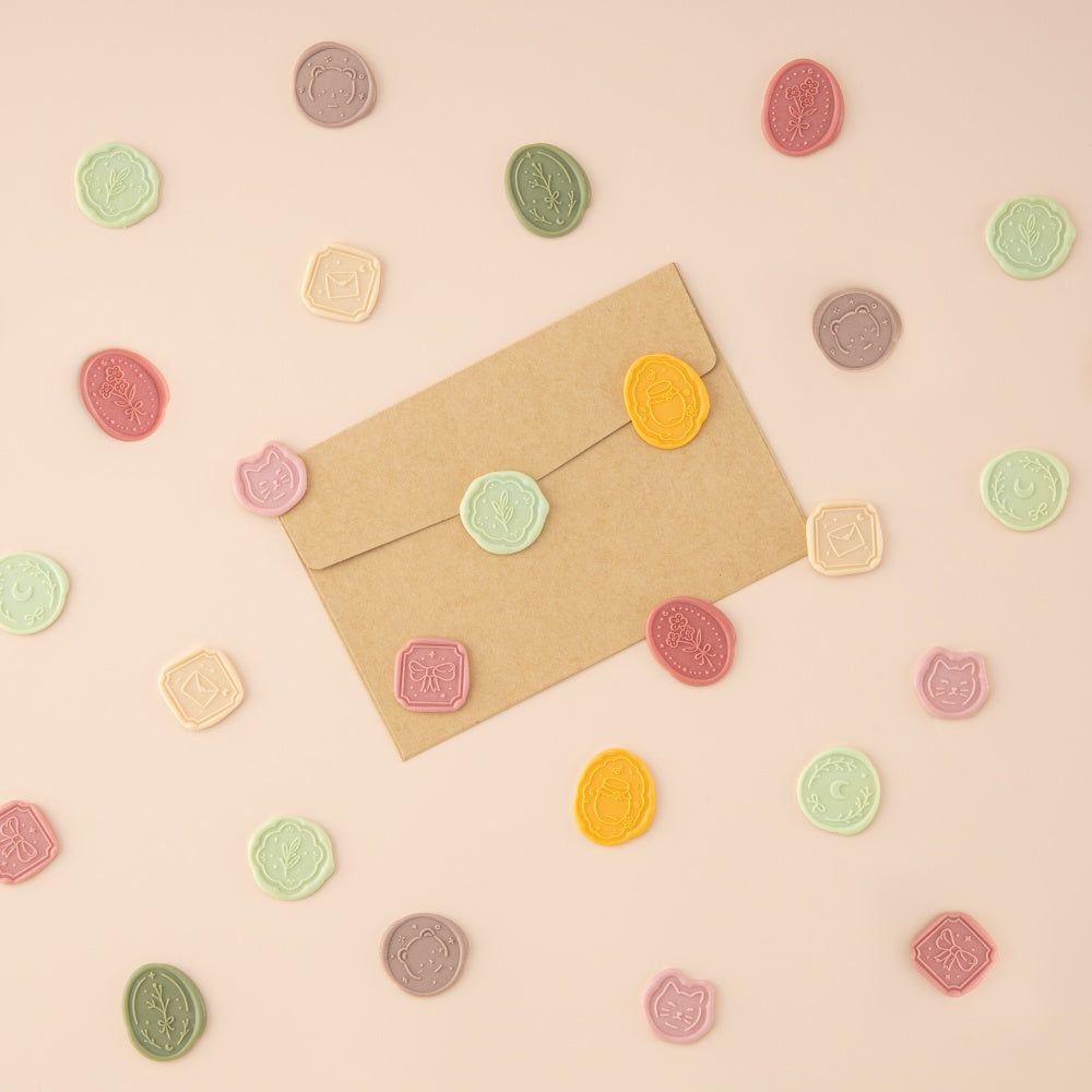Brown envelope with wax seal stickers on top