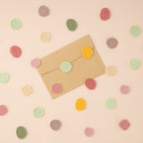 Brown envelope with wax seal stickers on top