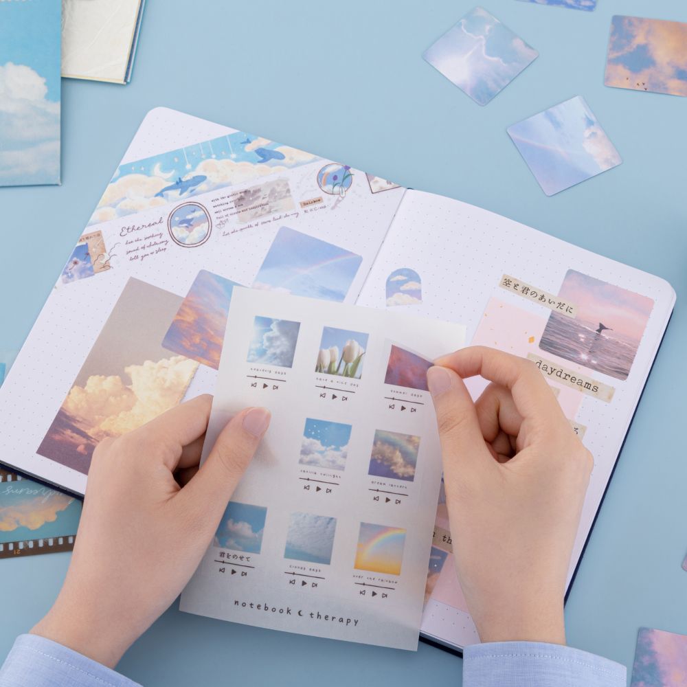 Model using playlist stickers from the sticker sheet to decorate bullet journal spread