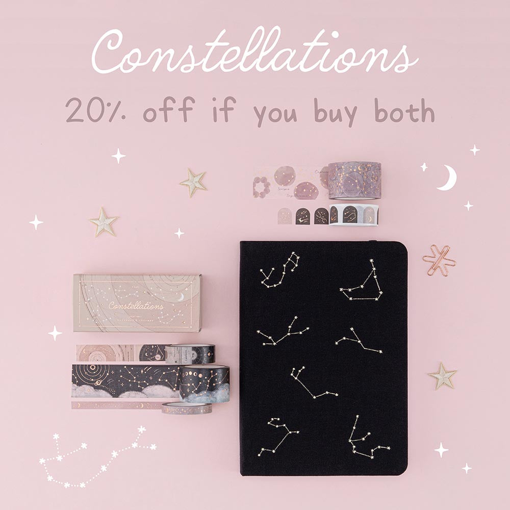 Constellations collection flatlay with black bullet journal on pink background - 20% off if you buy both