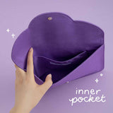 Hand opening the notebook pouch showing inner pocket