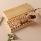 Hand picking up flower stamp from into the forest stamp set