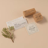 Stamp with the definition of shinrinyoku text reads “(n.) “forest bathing” spending time in the forest to enjoy the therapeutic benefits of the magical green light” and a stamp with bare feet walking on grass