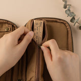 Hand zipping a pencil case with wooden stamp inside